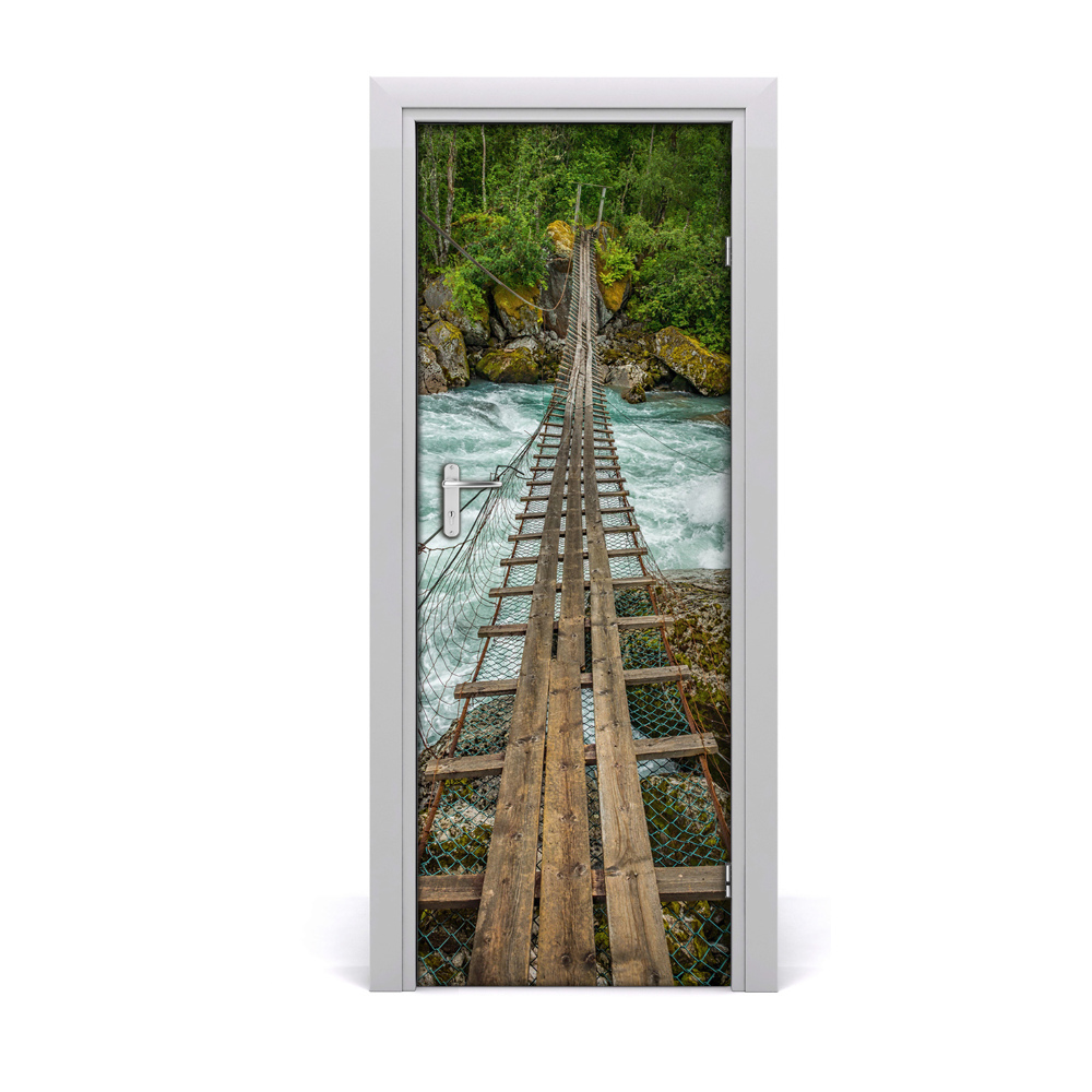 Sticker porte Pont suspendu au-dessus d'un ruisseau impétueux