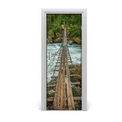Sticker porte Pont suspendu au-dessus d'un ruisseau impétueux