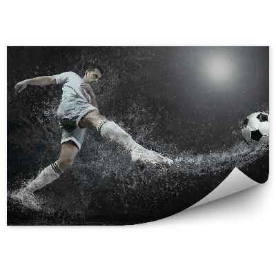 Papier peint Un ballon de football tombe dans l'eau