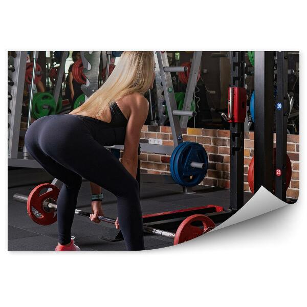 Papier peint Femme en train de soulever des poids dans une salle de sport