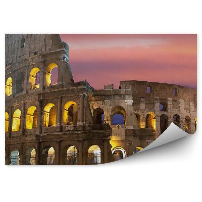Papier peint Le colisée illuminé sur fond de ciel coloré