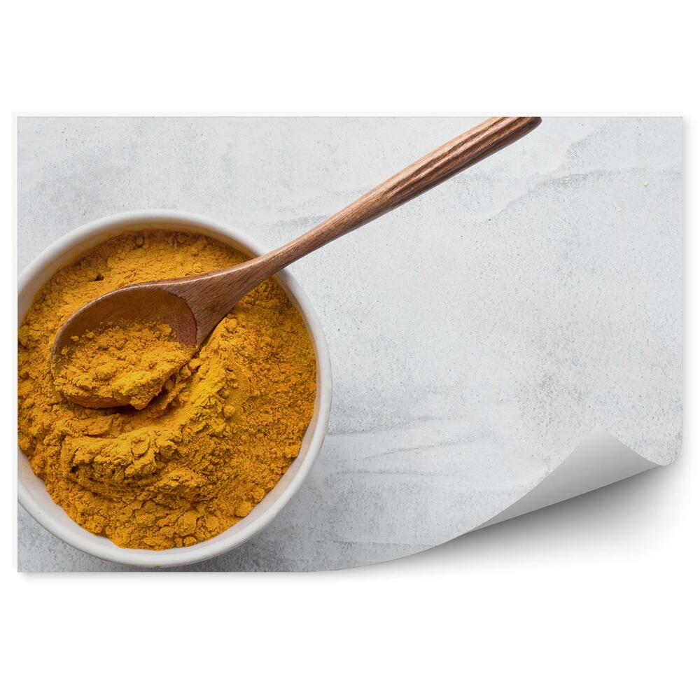 Papier peint Bol de curcuma sur socle en béton