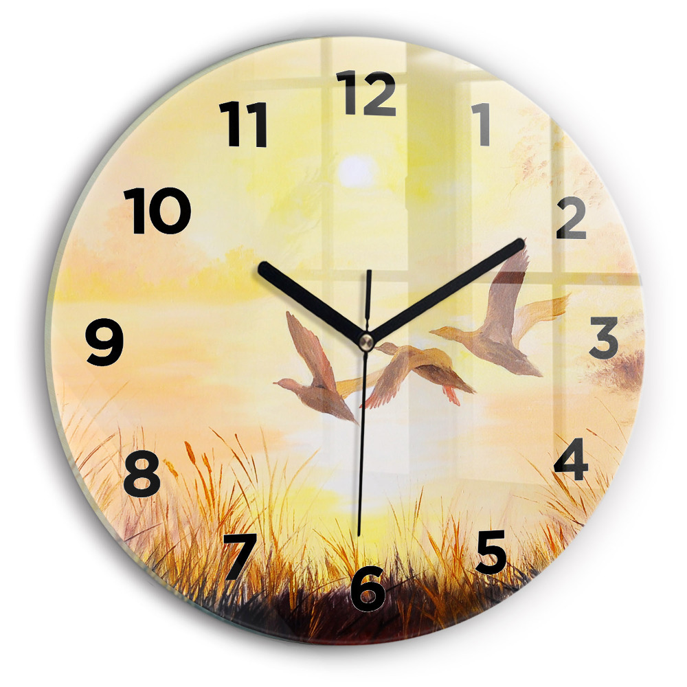 Horloge ronde en verre Grues au coucher du soleil
