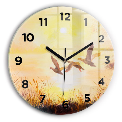 Horloge ronde en verre Grues au coucher du soleil